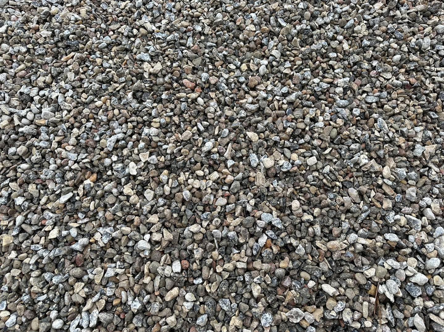 Eight shirts arranged on table in black, olive, grey, blue, white, red, mustard, and green.