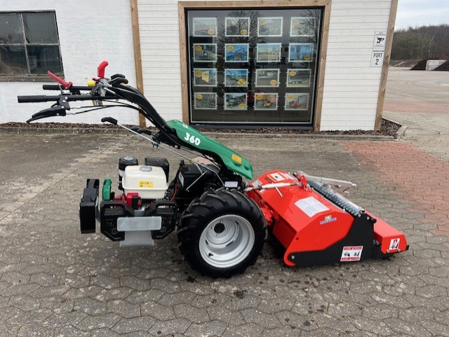 Eight shirts arranged on table in black, olive, grey, blue, white, red, mustard, and green.