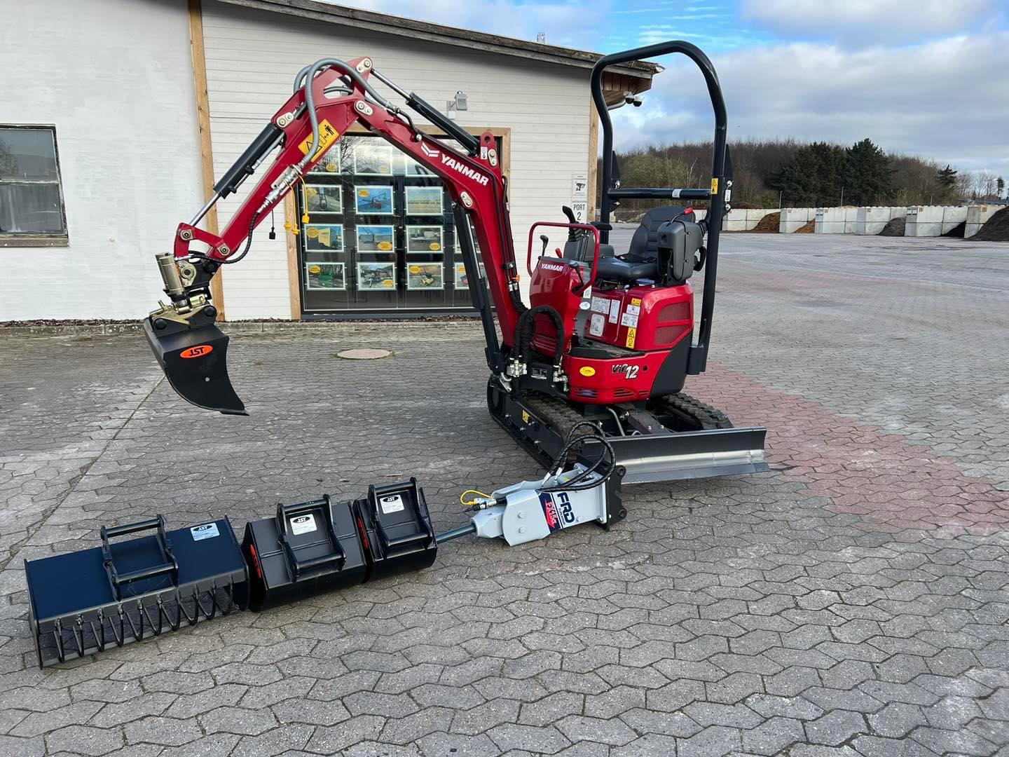 Eight shirts arranged on table in black, olive, grey, blue, white, red, mustard, and green.