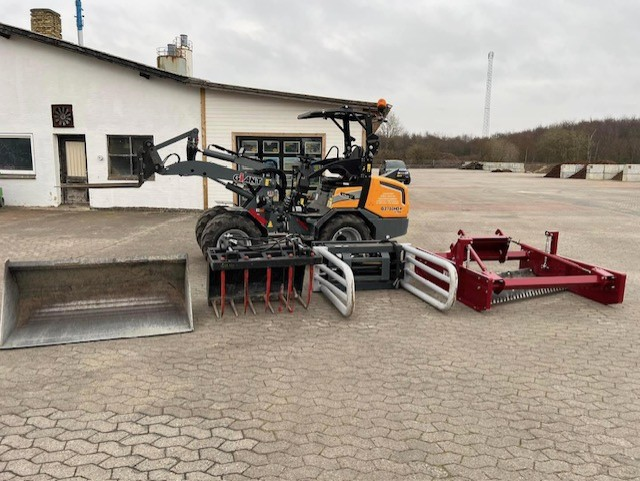 Eight shirts arranged on table in black, olive, grey, blue, white, red, mustard, and green.