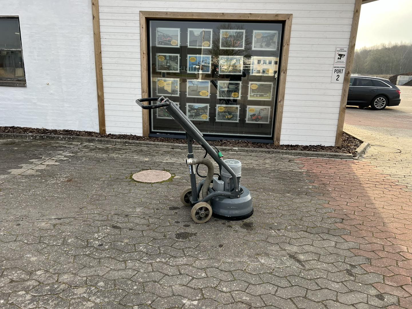 Eight shirts arranged on table in black, olive, grey, blue, white, red, mustard, and green.