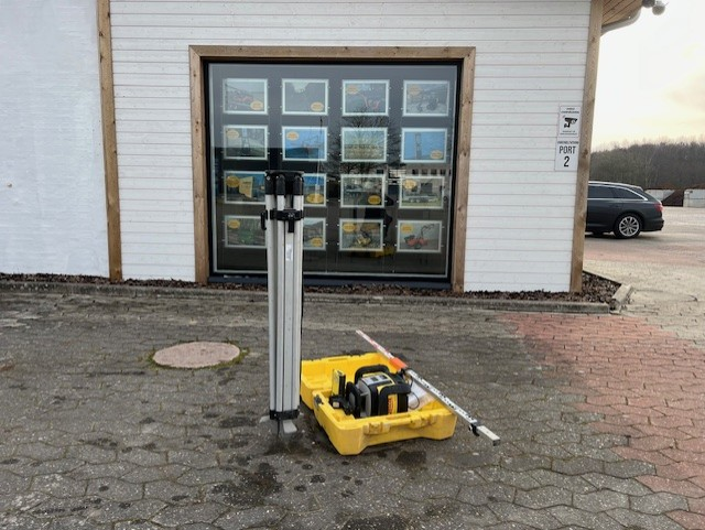 Eight shirts arranged on table in black, olive, grey, blue, white, red, mustard, and green.