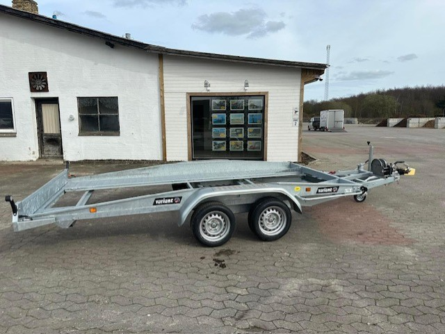 Eight shirts arranged on table in black, olive, grey, blue, white, red, mustard, and green.