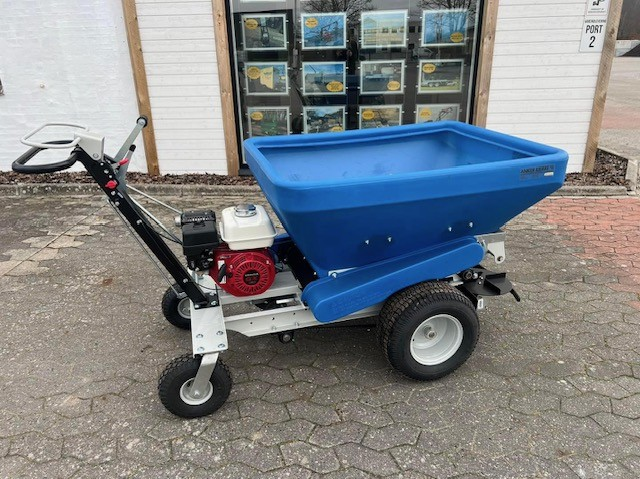 Eight shirts arranged on table in black, olive, grey, blue, white, red, mustard, and green.