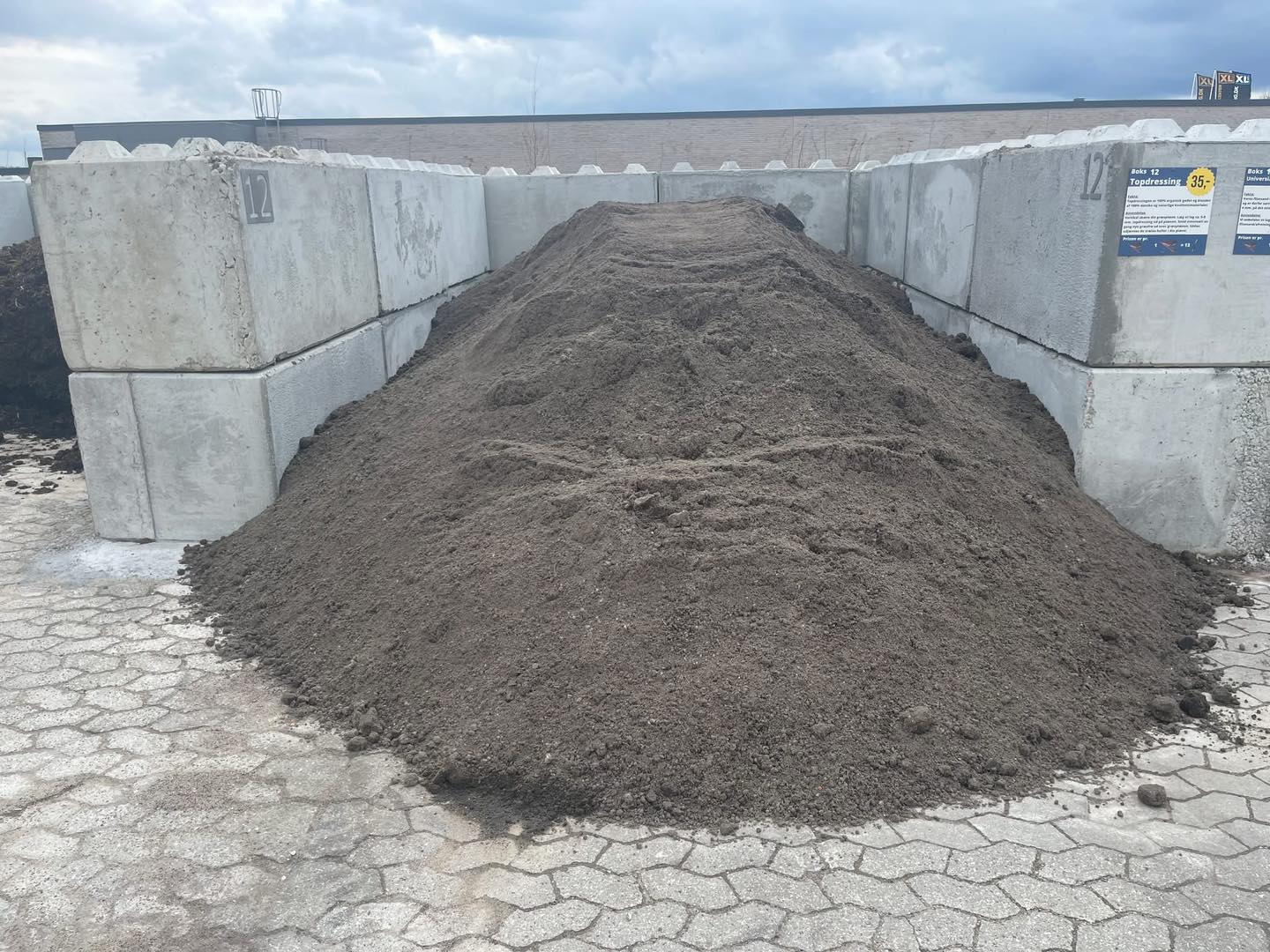 Eight shirts arranged on table in black, olive, grey, blue, white, red, mustard, and green.