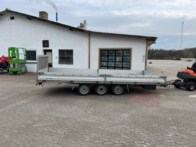Eight shirts arranged on table in black, olive, grey, blue, white, red, mustard, and green.