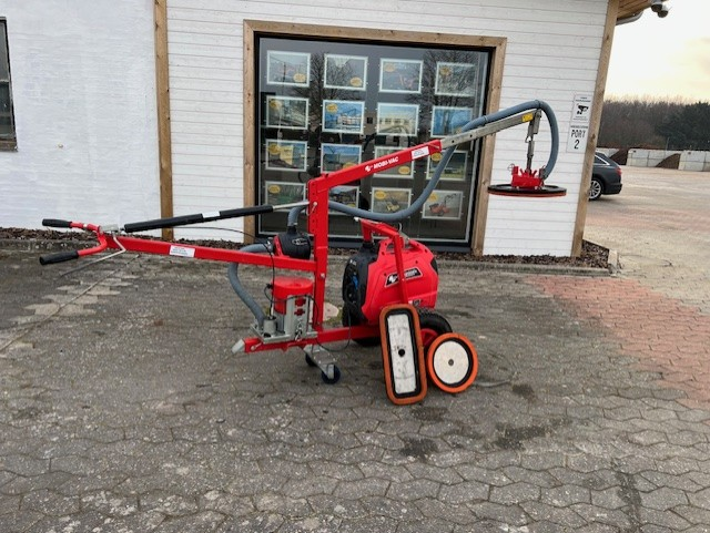 Eight shirts arranged on table in black, olive, grey, blue, white, red, mustard, and green.