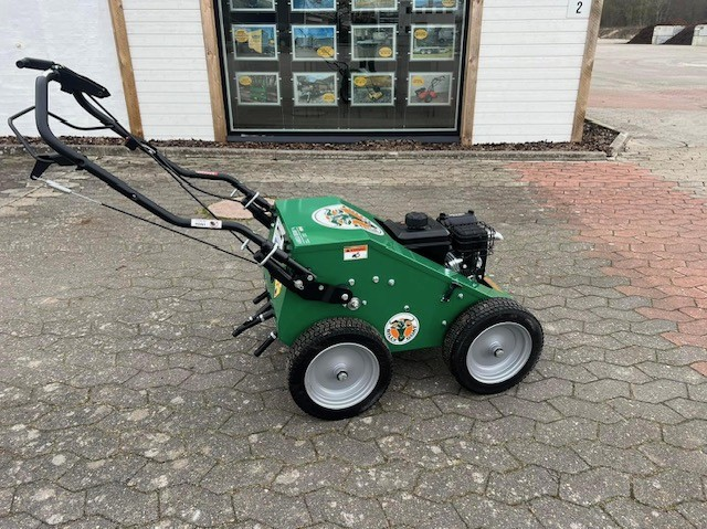 Eight shirts arranged on table in black, olive, grey, blue, white, red, mustard, and green.