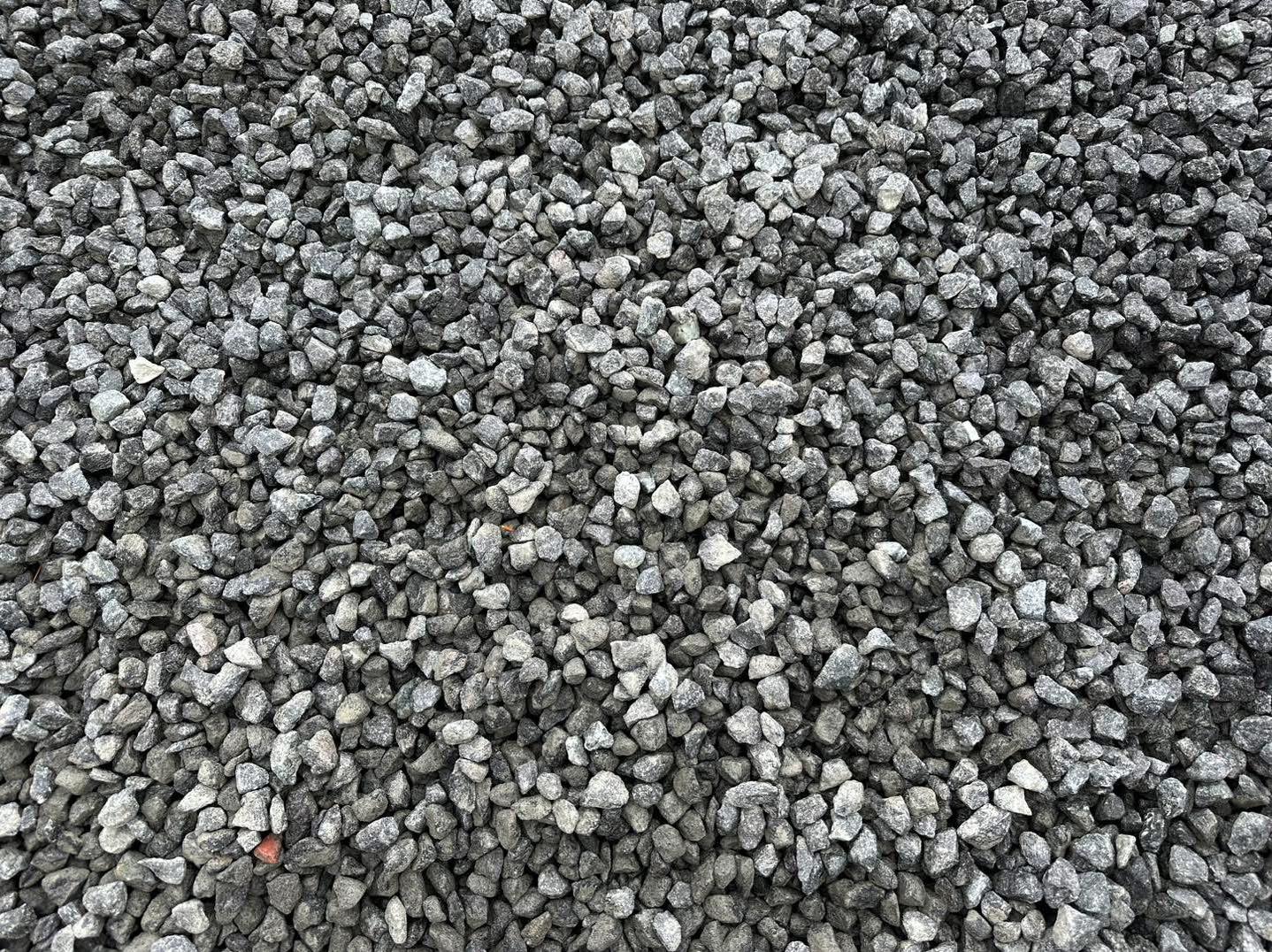 Eight shirts arranged on table in black, olive, grey, blue, white, red, mustard, and green.