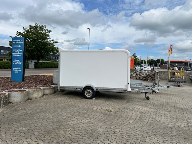 Eight shirts arranged on table in black, olive, grey, blue, white, red, mustard, and green.