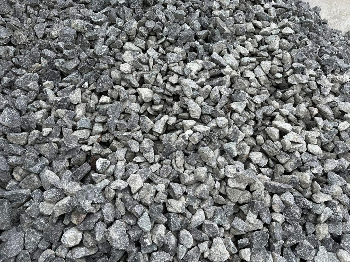 Eight shirts arranged on table in black, olive, grey, blue, white, red, mustard, and green.