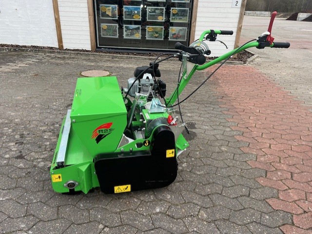 Eight shirts arranged on table in black, olive, grey, blue, white, red, mustard, and green.