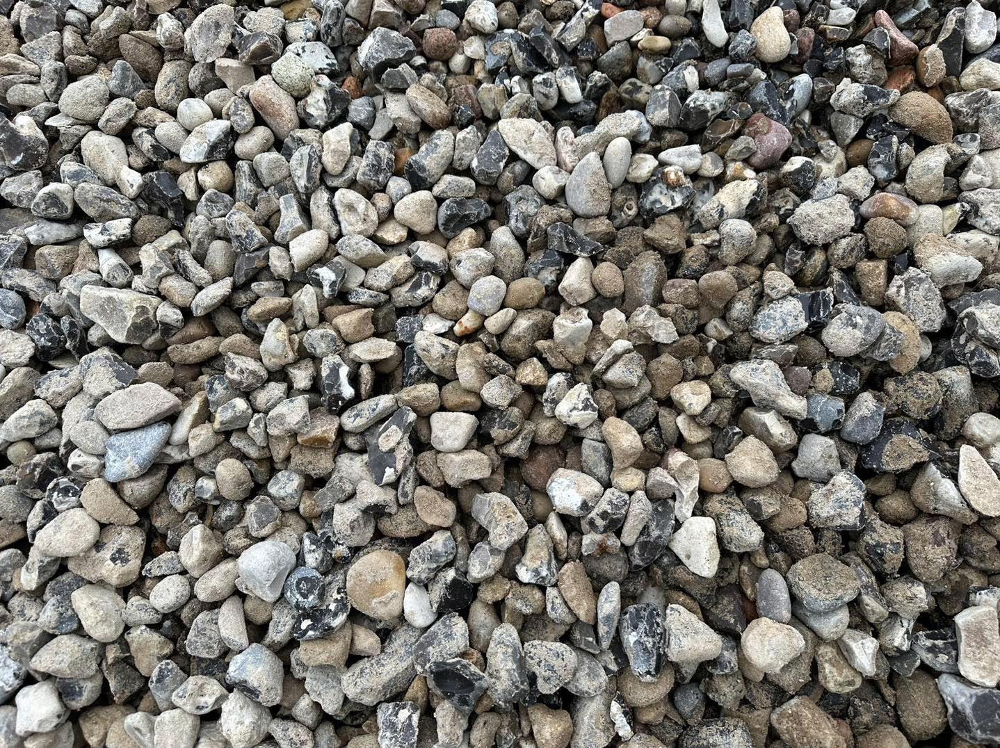 Eight shirts arranged on table in black, olive, grey, blue, white, red, mustard, and green.