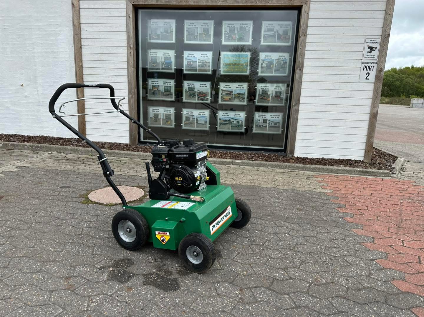 Eight shirts arranged on table in black, olive, grey, blue, white, red, mustard, and green.