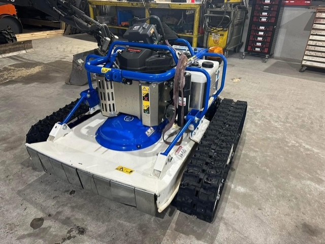 Eight shirts arranged on table in black, olive, grey, blue, white, red, mustard, and green.