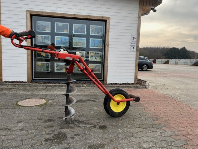 Eight shirts arranged on table in black, olive, grey, blue, white, red, mustard, and green.